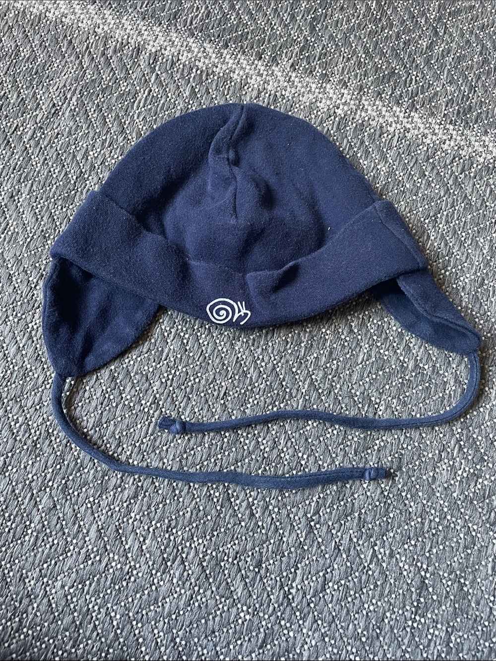 Navy Earflap Hat with White Snail Motif